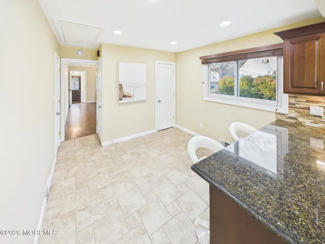 a bathroom with a granite countertop sink and mirror