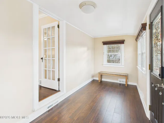 a view of a livingroom with wooden floor and a window
