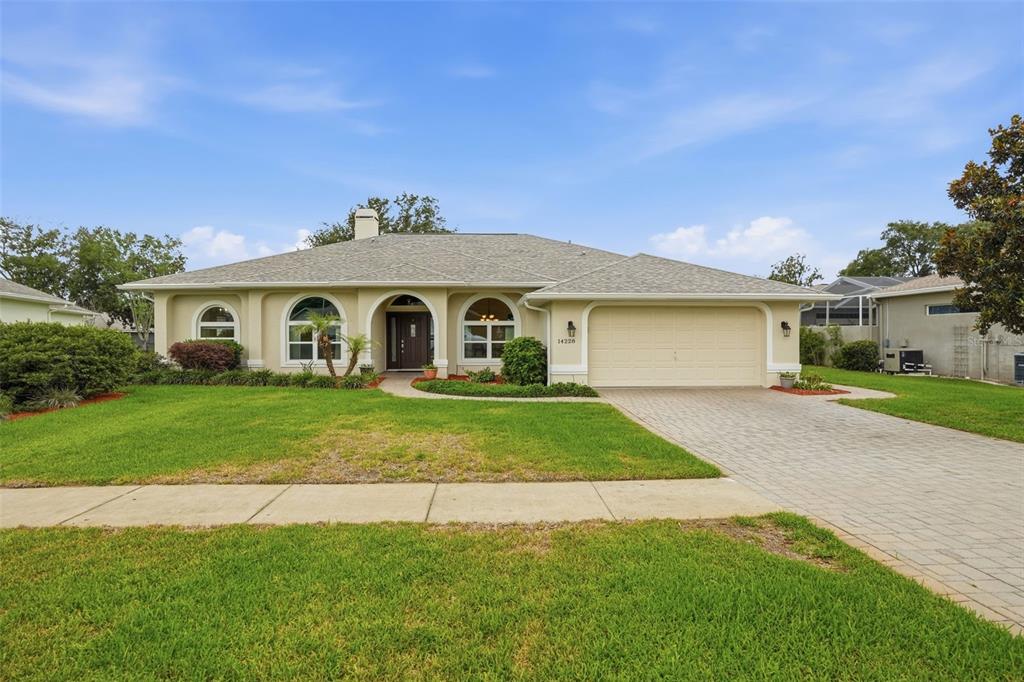 14228 Presteign Lane Spring Hill, FL 34609 - Photo 3 of 89 a front view of a house with a yard and garage