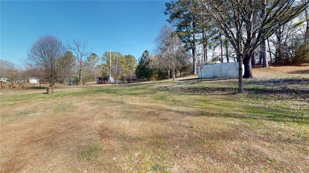 189 Boyd Valley Road Southeast Rome, GA 30161 - Photo 11 of 28 a yard with trees and a building