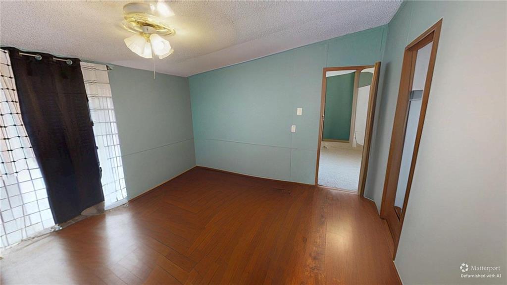189 Boyd Valley Road Southeast Rome, GA 30161 - Photo 20 of 28 an empty room with wooden floor and mirror