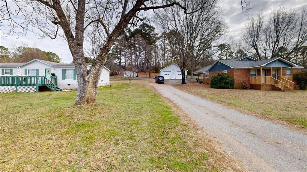 189 Boyd Valley Road Southeast Rome, GA 30161 - Photo 7 of 28 a view of a yard with a large tree in front of the house