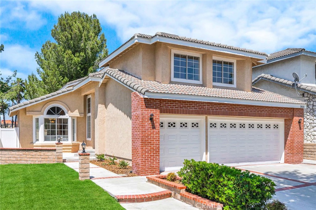 3031 Mountainside Drive Corona, CA 92882 - Photo 1 of 18 a front view of a house with a yard