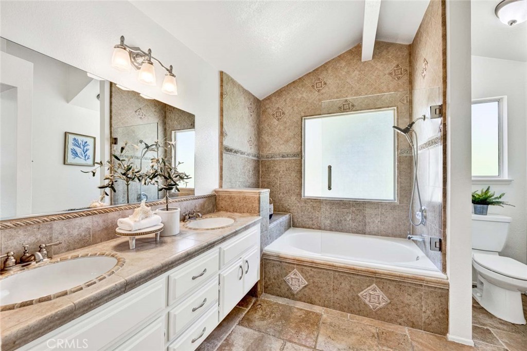 3031 Mountainside Drive Corona, CA 92882 - Photo 11 of 18 a bathroom with a granite countertop tub sink and mirror