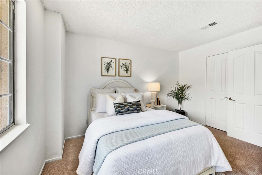 3031 Mountainside Drive Corona, CA 92882 - Photo 12 of 18 a bedroom with a bed and painting on the wall