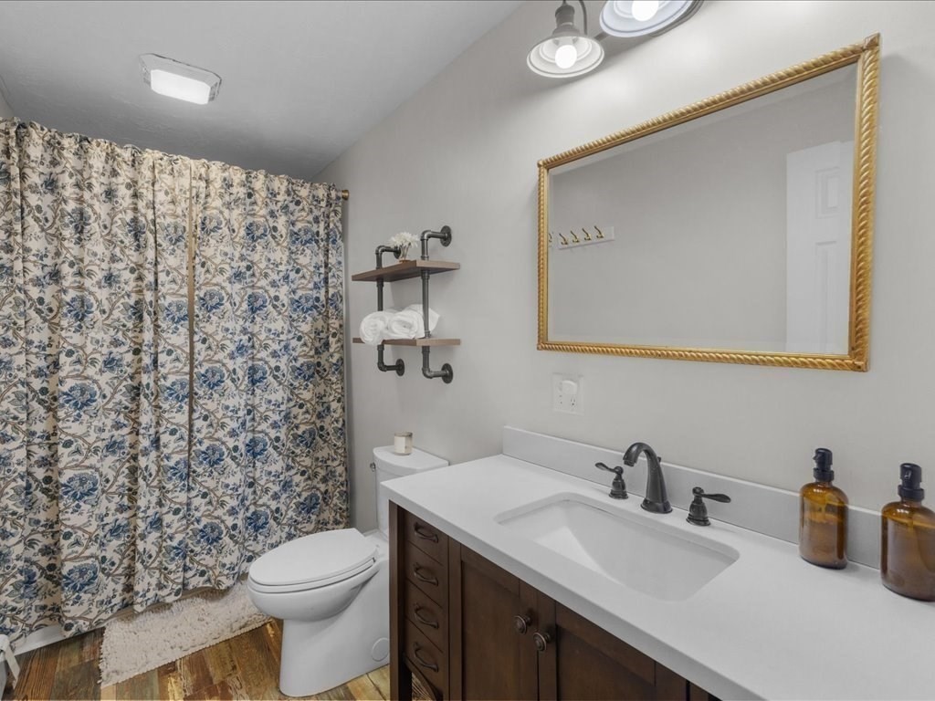 7 Pierce Road Marshfield, MA 02050 - Photo 12 of 34 a bathroom with a toilet sink and mirror