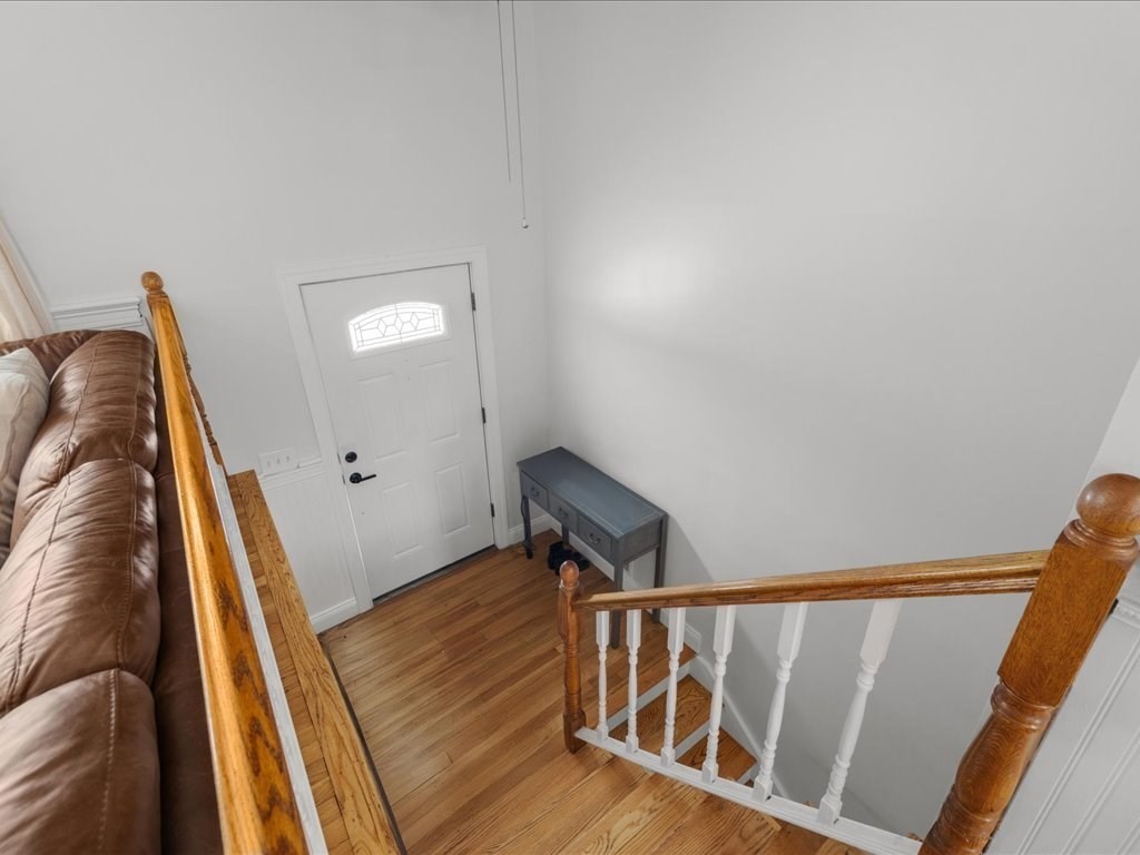 7 Pierce Road Marshfield, MA 02050 - Photo 5 of 34 a view of a hallway with wooden floor and stairs