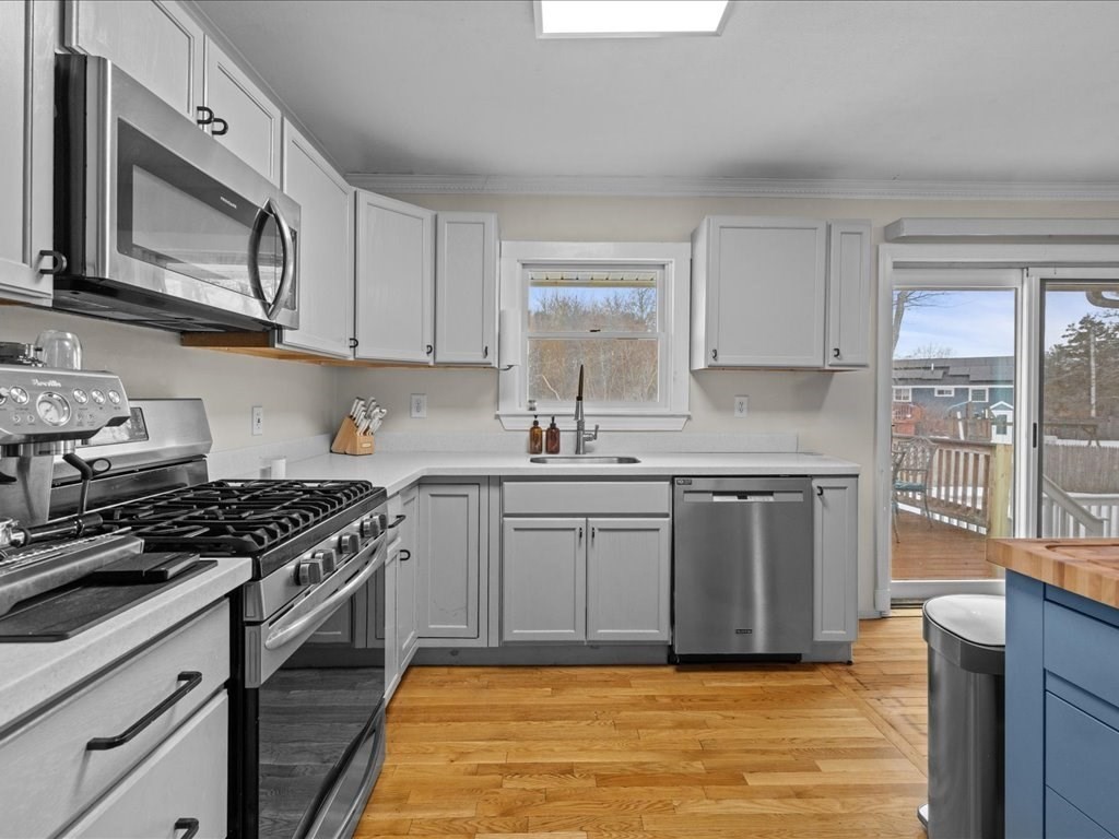 7 Pierce Road Marshfield, MA 02050 - Photo 9 of 34 a kitchen with stainless steel appliances granite countertop a stove a sink and a white cabinets