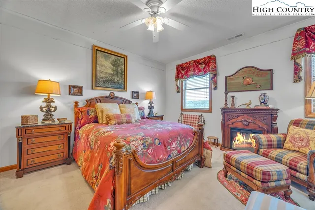 a bedroom with a bed couch and a window