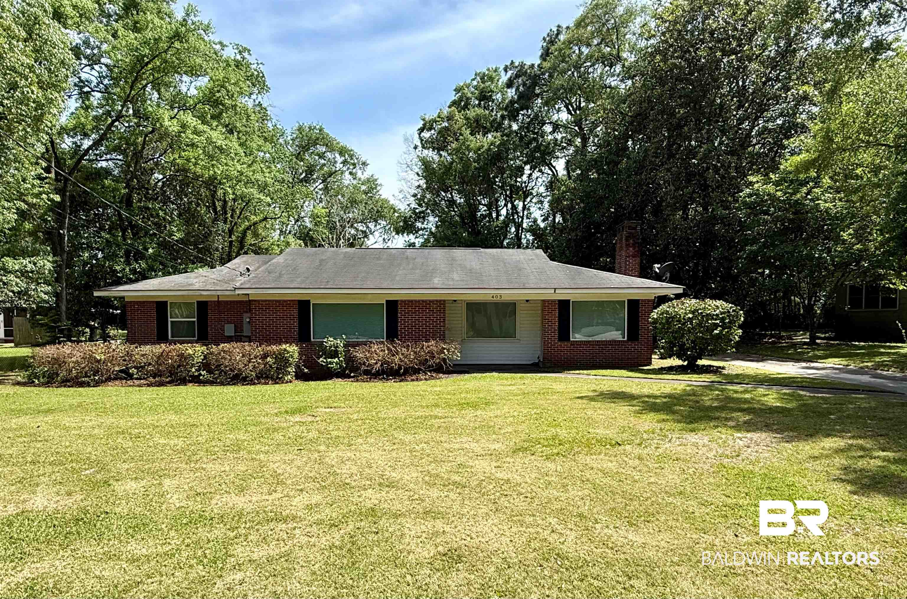 403 Sutherland Drive Mobile, AL 36611 - Photo 1 of 8 Single story home with a front yard, a chimney, and brick siding