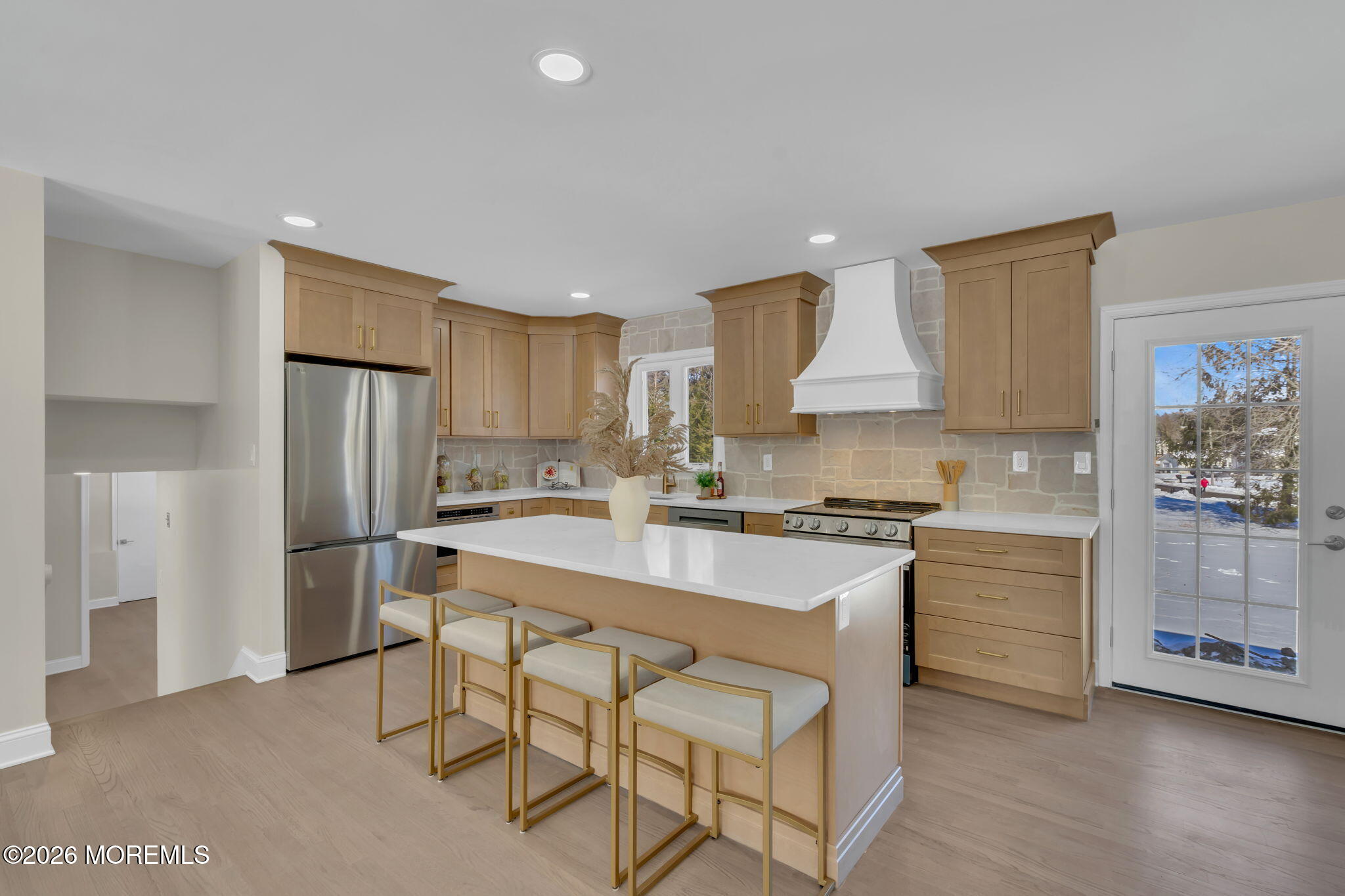 568 Flock Road Hamilton Square, NJ 08690 - Photo 36 of 65 a kitchen with kitchen island a stove a refrigerator and white cabinets with wooden floor