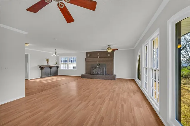 a view of a hallway with wooden floor and entryway