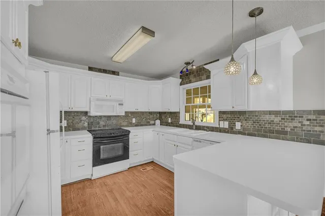 a kitchen with a stove and a sink