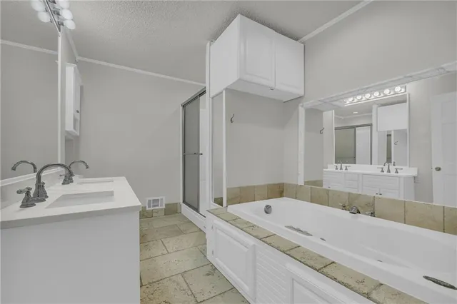 a bathroom with a tub a sink and mirror