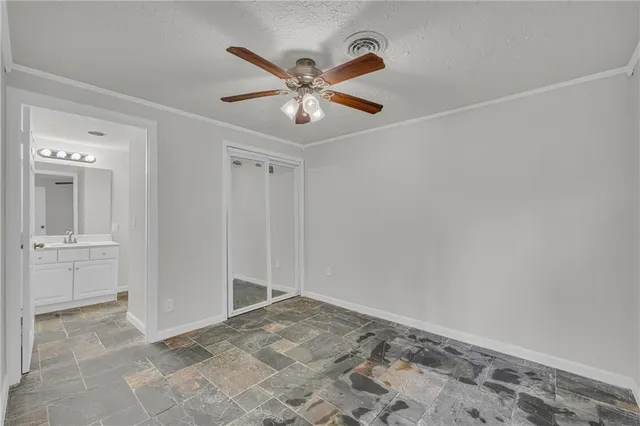 a view of a livingroom with a ceiling fan and wooden floor