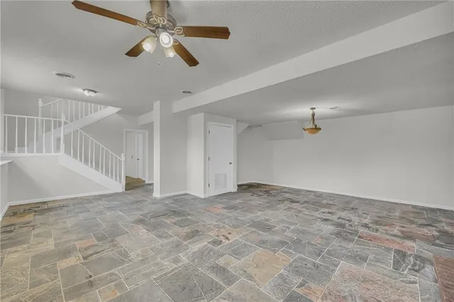 a view of empty room with ceiling fan
