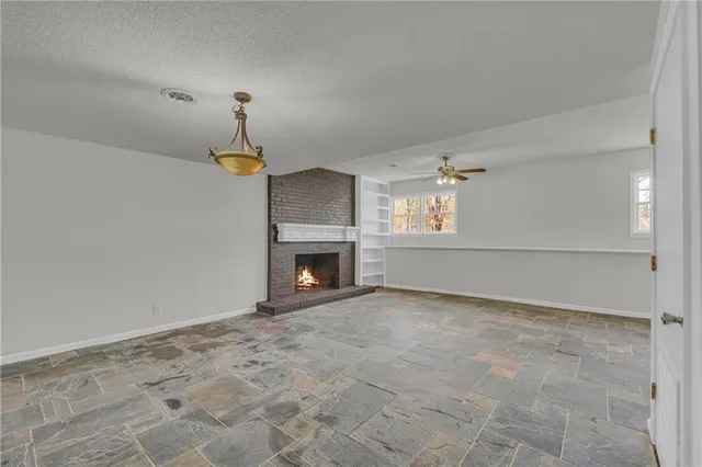 a view of empty room with fireplace
