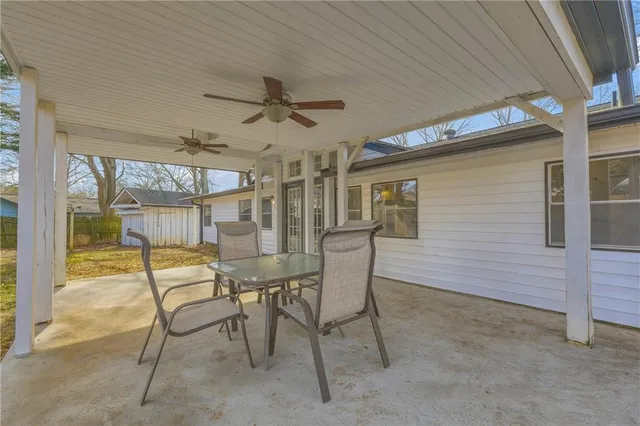 a dining room with a wooden table and chairs