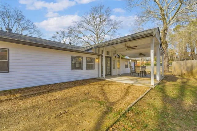 a view of a house with a backyard
