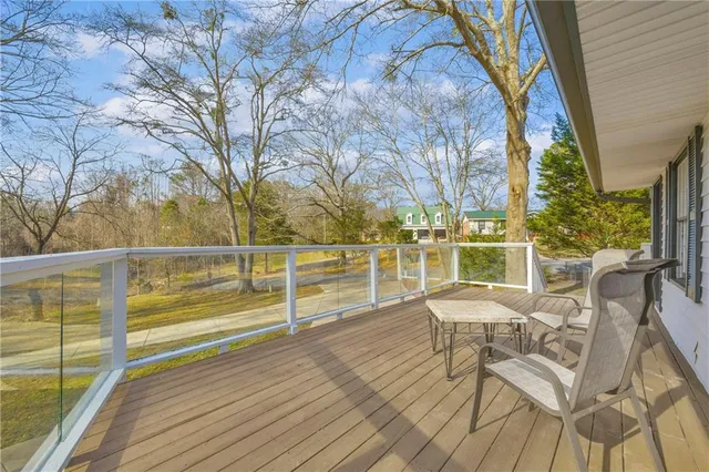 a view of a chairs and table on the wooden deck