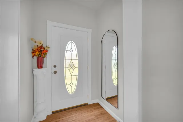 a view of an entryway with wooden floor