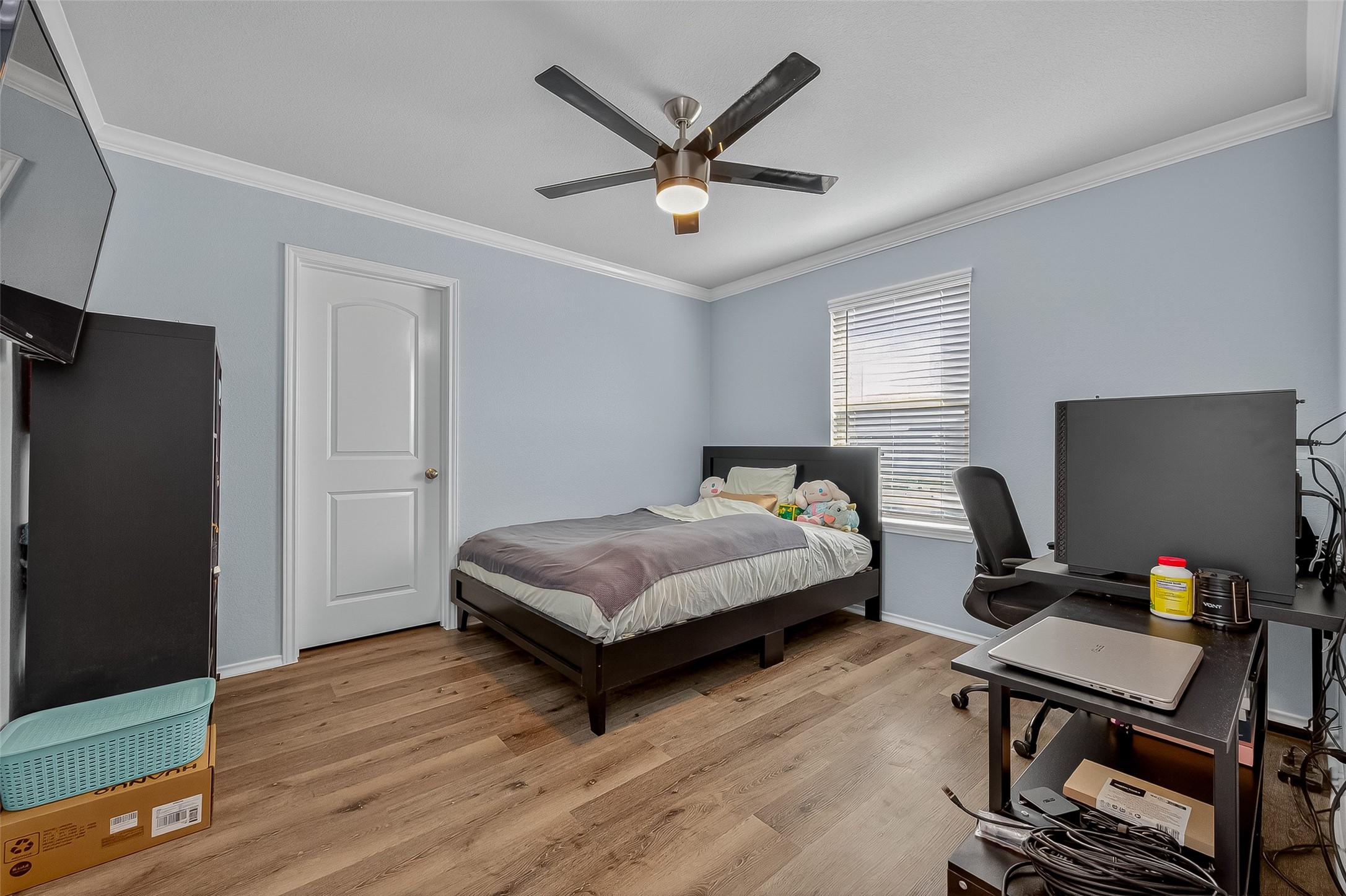 9253 Inland Leather Lane Conroe, TX 77385 - Photo 14 of 34 a bedroom with a bed and a desk