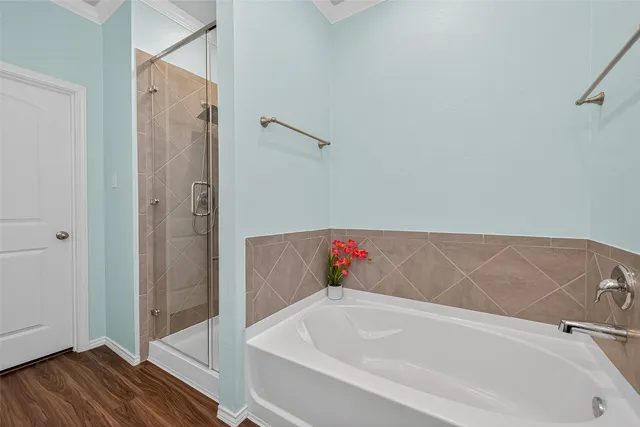 a bathroom with a tub and shower