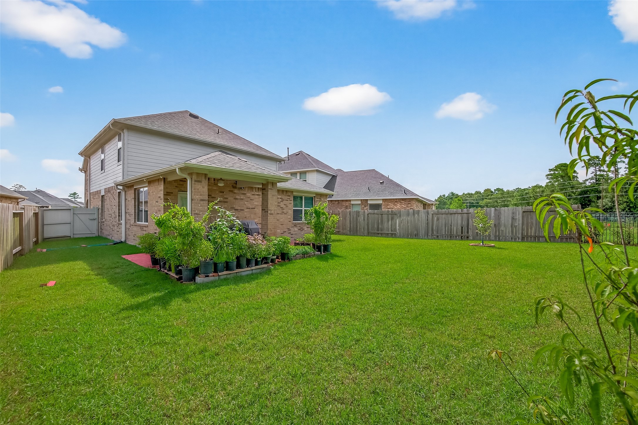 9253 Inland Leather Lane Conroe, TX 77385 - Photo 29 of 34 a front view of house with garden
