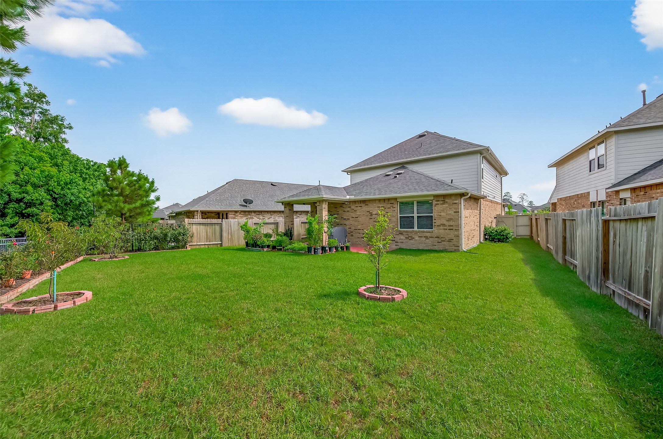 9253 Inland Leather Lane Conroe, TX 77385 - Photo 30 of 34 a front view of house with a garden