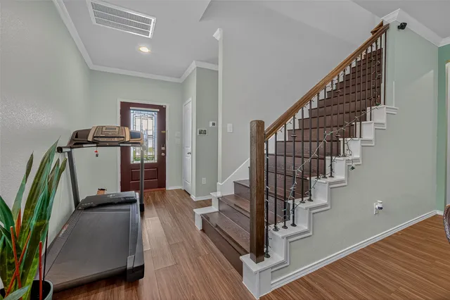 a view of entryway and hall with wooden floor