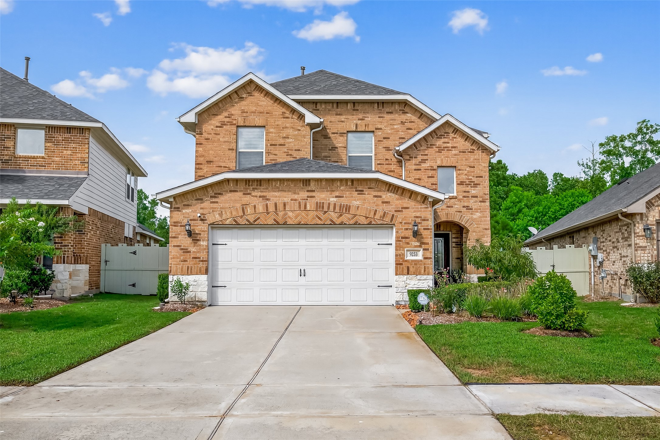 9253 Inland Leather Lane Conroe, TX 77385 - Photo 32 of 34 a front view of a house with a yard and garage