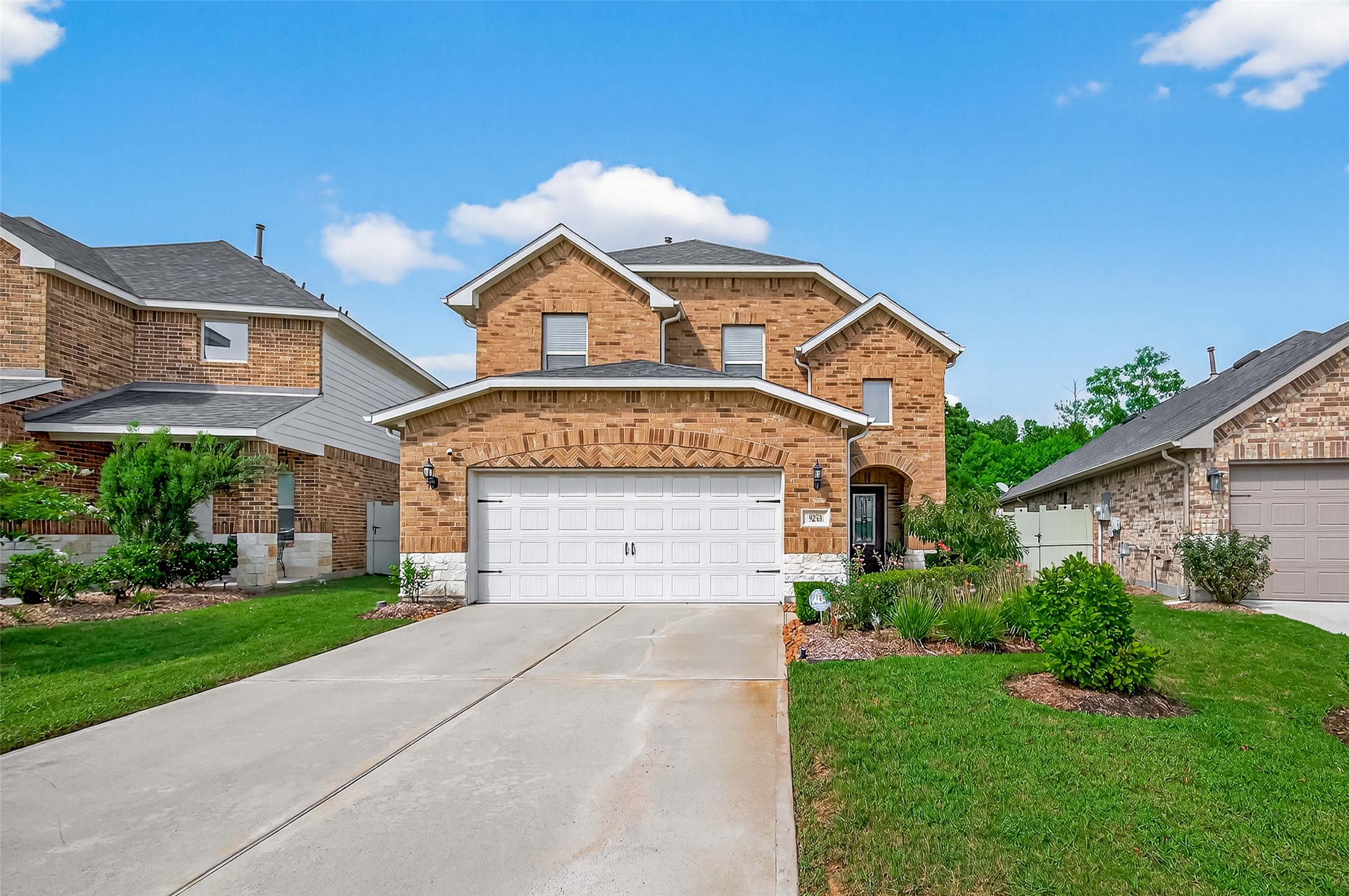 9253 Inland Leather Lane Conroe, TX 77385 - Photo 34 of 34 a front view of a house with a yard