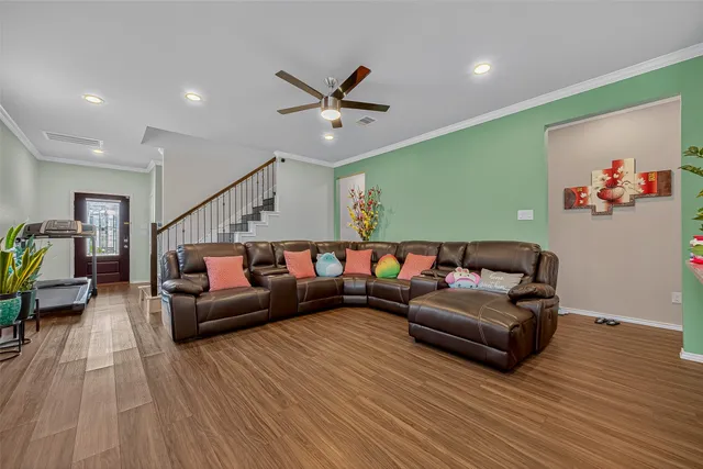 a living room with furniture and wooden floor