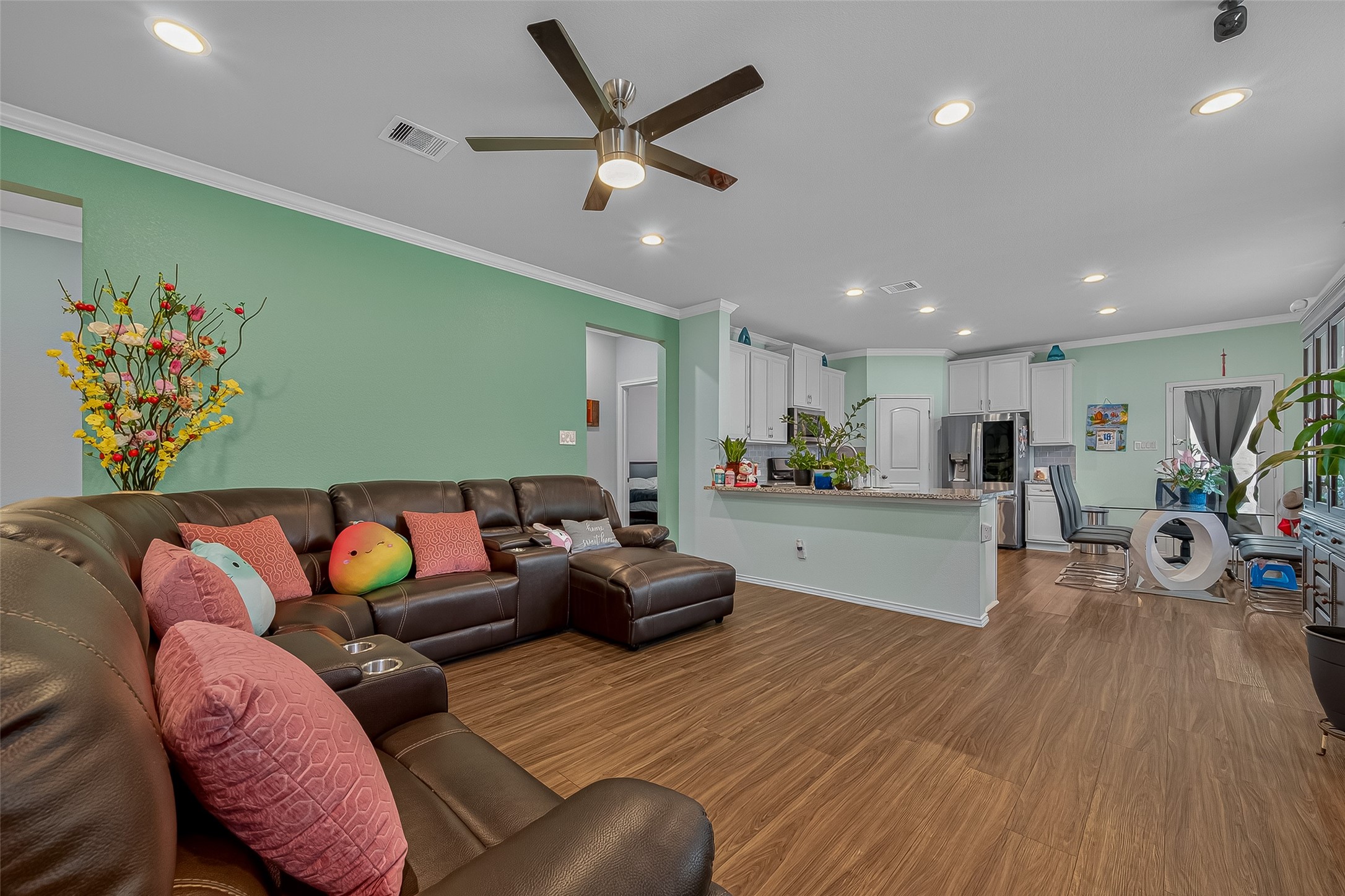 9253 Inland Leather Lane Conroe, TX 77385 - Photo 10 of 34 a living room with furniture kitchen view and a wooden floor