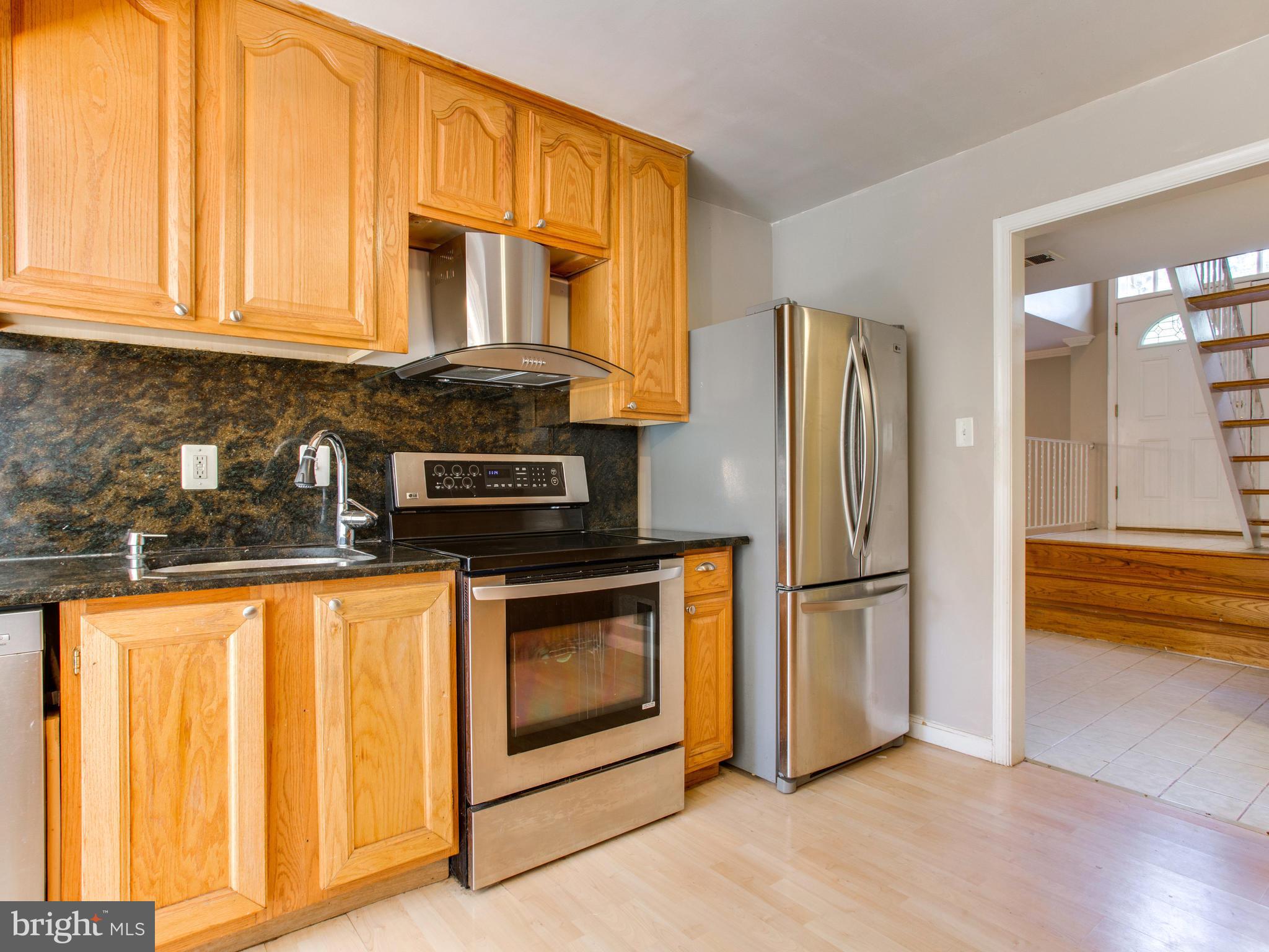 9819 Greenview Lane Manassas, VA 20109 - Photo 12 of 30 Kitchen stove, vent and refridgerator