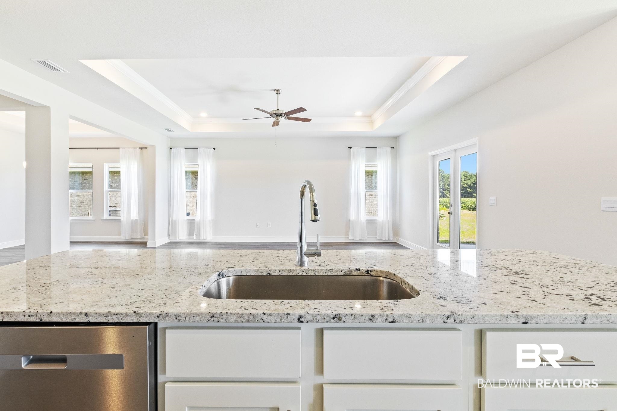 11303 Genuine Risk Circle Daphne, AL 36526 - Photo 24 of 100 Kitchen featuring ceiling fan, a raised ceiling, light stone counters, dishwasher, and sink