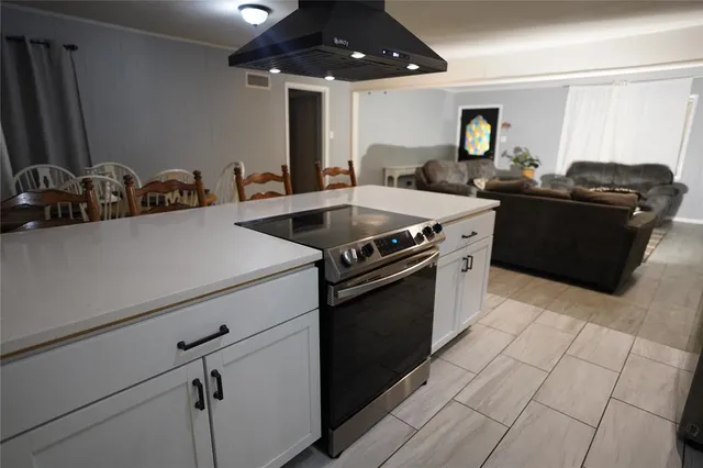 a backyard of a house with barbeque oven table and chairs