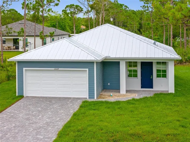 a view of a house with a garden and yard