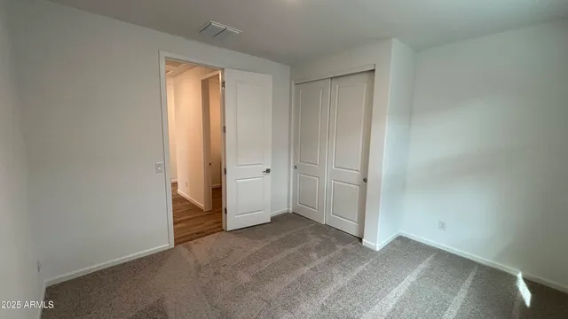 an empty room with closet area