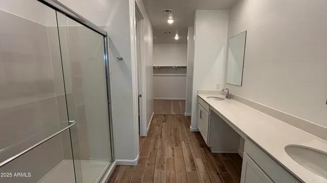 a bathroom with a double vanity sink and mirror