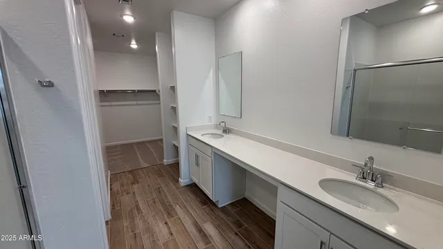 a bathroom with a double vanity sink and mirror
