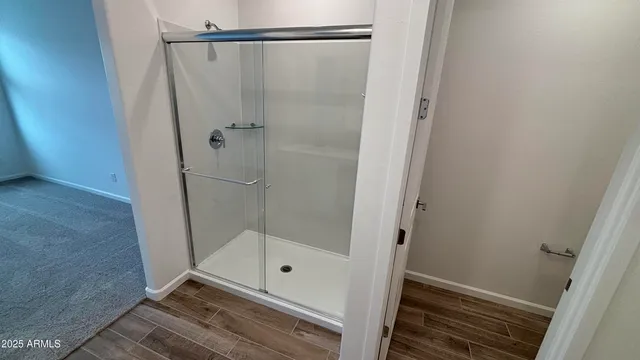 a bathroom with a glass shower door