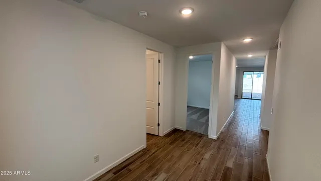 a view of hallway with wooden floor