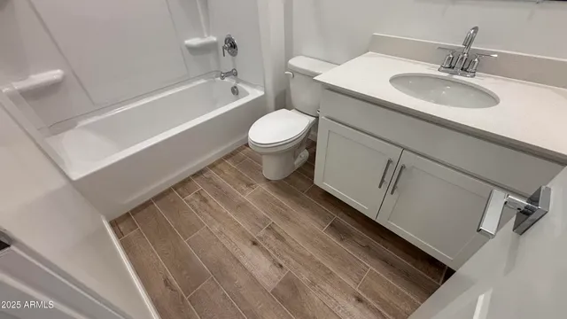 a bathroom with a sink a toilet and bathtub