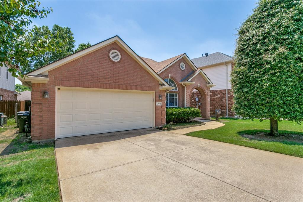 12612 Red Cedar Drive Fort Worth, TX 76040 - Photo 1 of 1 a front view of a house with a yard and garage