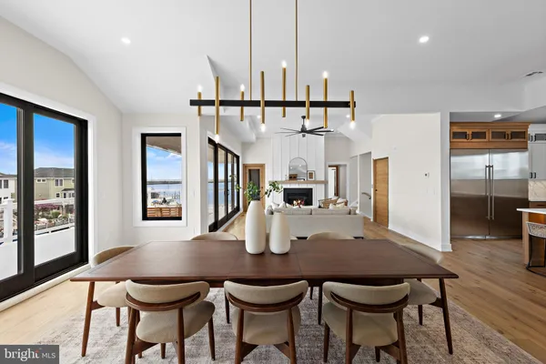 a kitchen with kitchen island a table and chairs in it