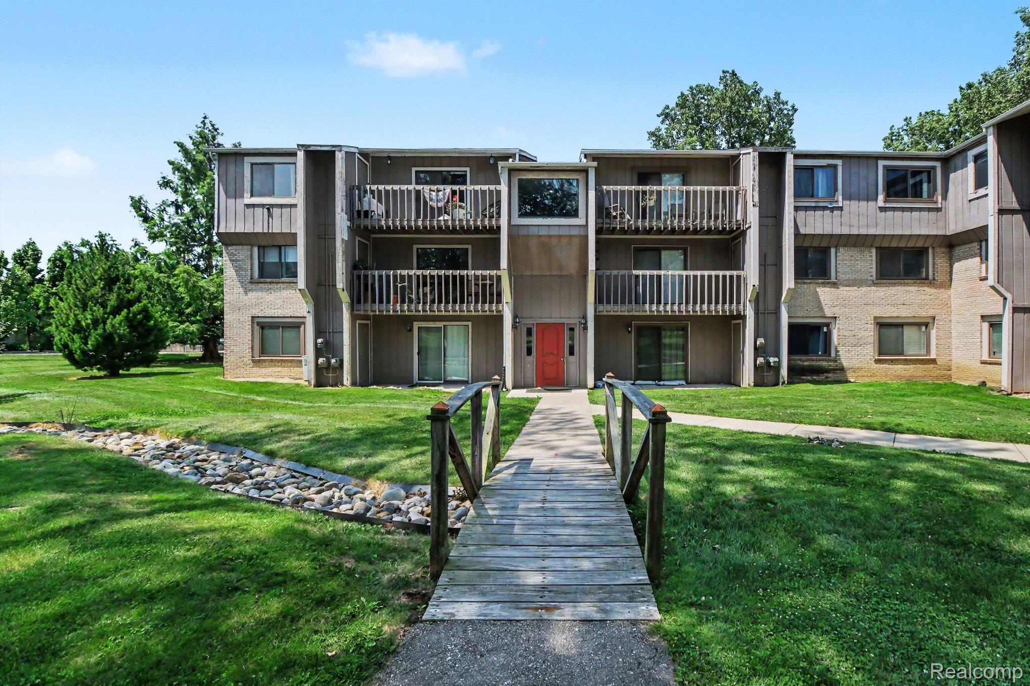 Multi-story apartment building featuring a brick and siding facade