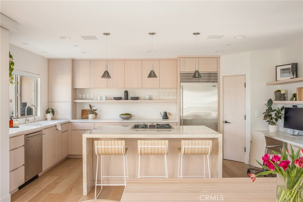 2702 The Strand Manhattan Beach, CA 90266 - Photo 14 of 52 a kitchen with a sink stove and cabinets