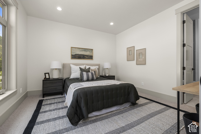 1175 North Elk Rdg Lane, Unit 201 Alpine, UT 84004 - Photo 3 of 38 Recessed lighting illuminates this room featuring a window with a mountain backdrop, neutral wall tones, and light-toned carpet flooring