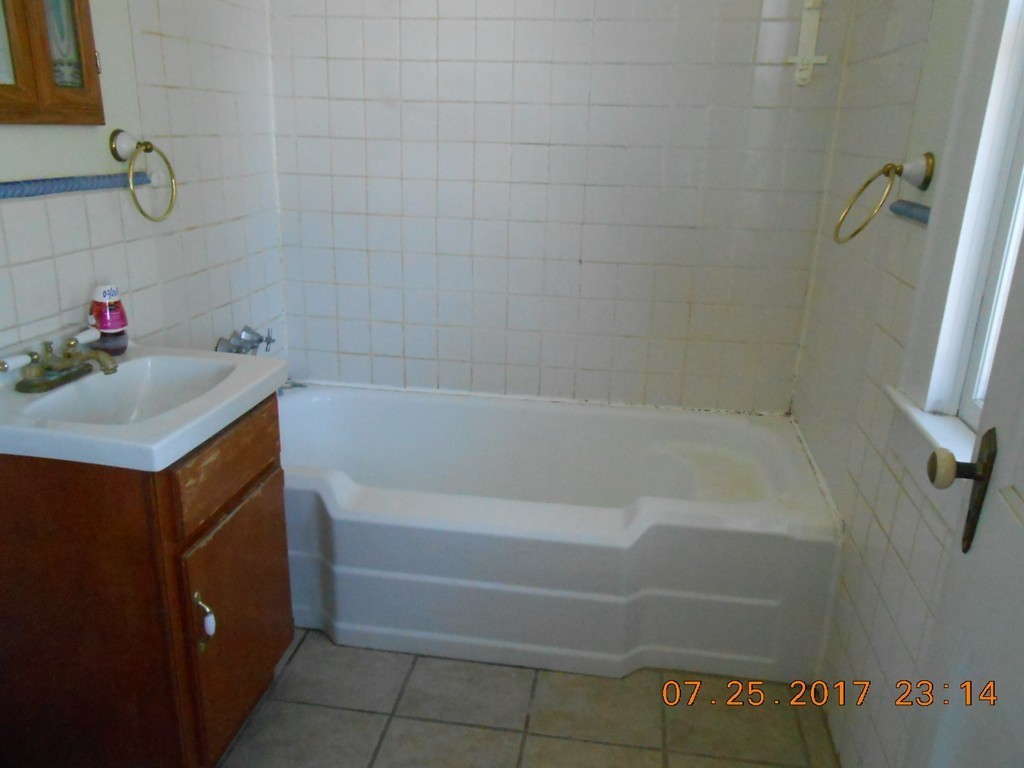 30 Brandon Avenue Springfield, MA 01119 - Photo 8 of 13 a bathroom with a bathtub sink and a shower